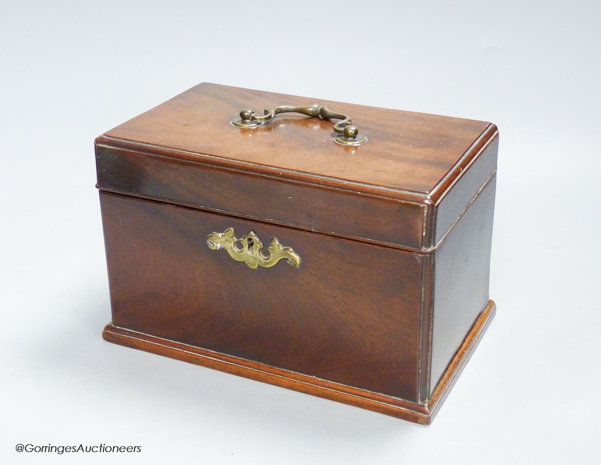 A George III mahogany tea caddy, with a concealed drawer to one end, width 22cm height 14cm